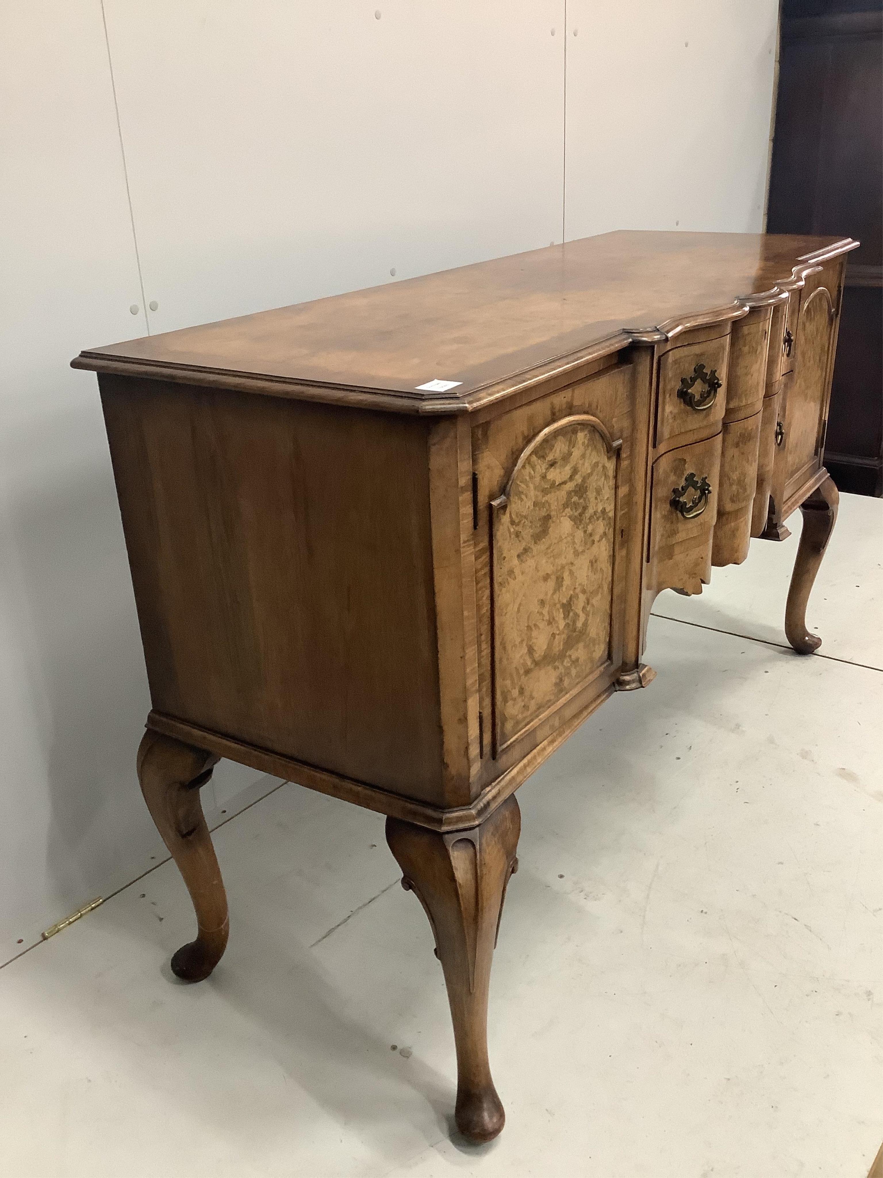 A Queen Anne Revival serpentine walnut sideboard, width 152cm, depth 59cm, height 93cm. Condition - fair